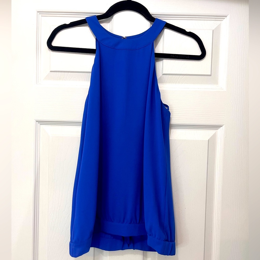 Sleeveless blouse with adorable back details.